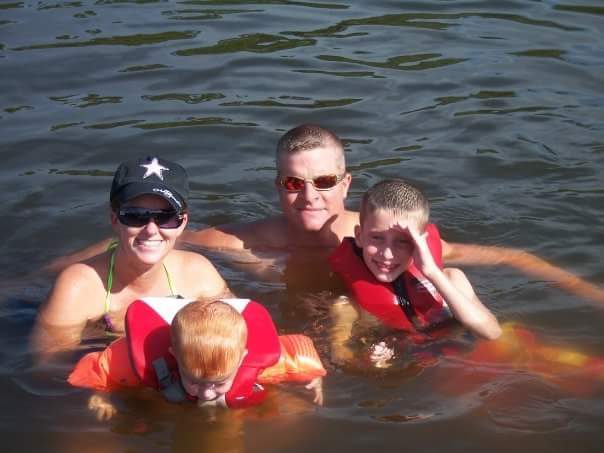 A Family Of Two Children Doing Swim