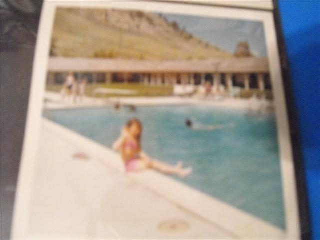 A Little Child Sat At The Swimming Pool